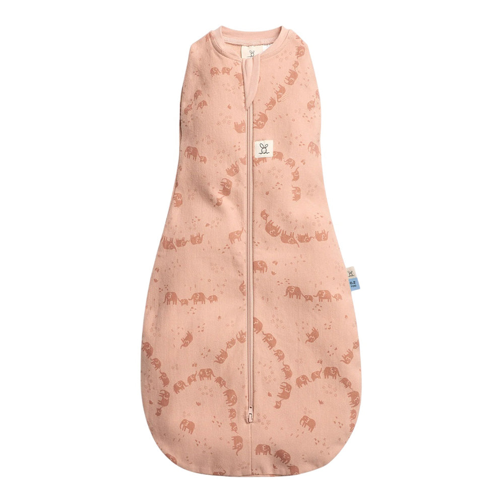 The ErgoPouch 0.2 Tog Cocoon Elephant Parade by ErgoPouch is a pink sleeveless swaddle bag for newborns with a front zipper, all-over brown elephant print, rounded roomy bottom, and a white neck tag.