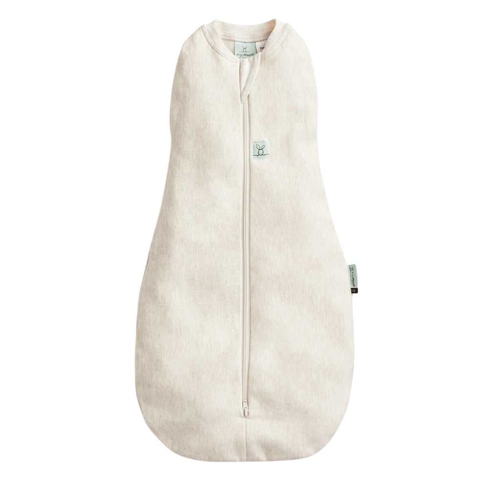 The ErgoPouch 1.0 Tog Cocoon Oatmeal Marle by ErgoPouch is a beige, sleeveless baby sleep sack made from soft organic cotton with a front zipper and a small embroidered animal logo, offering cozy comfort for your little one.
