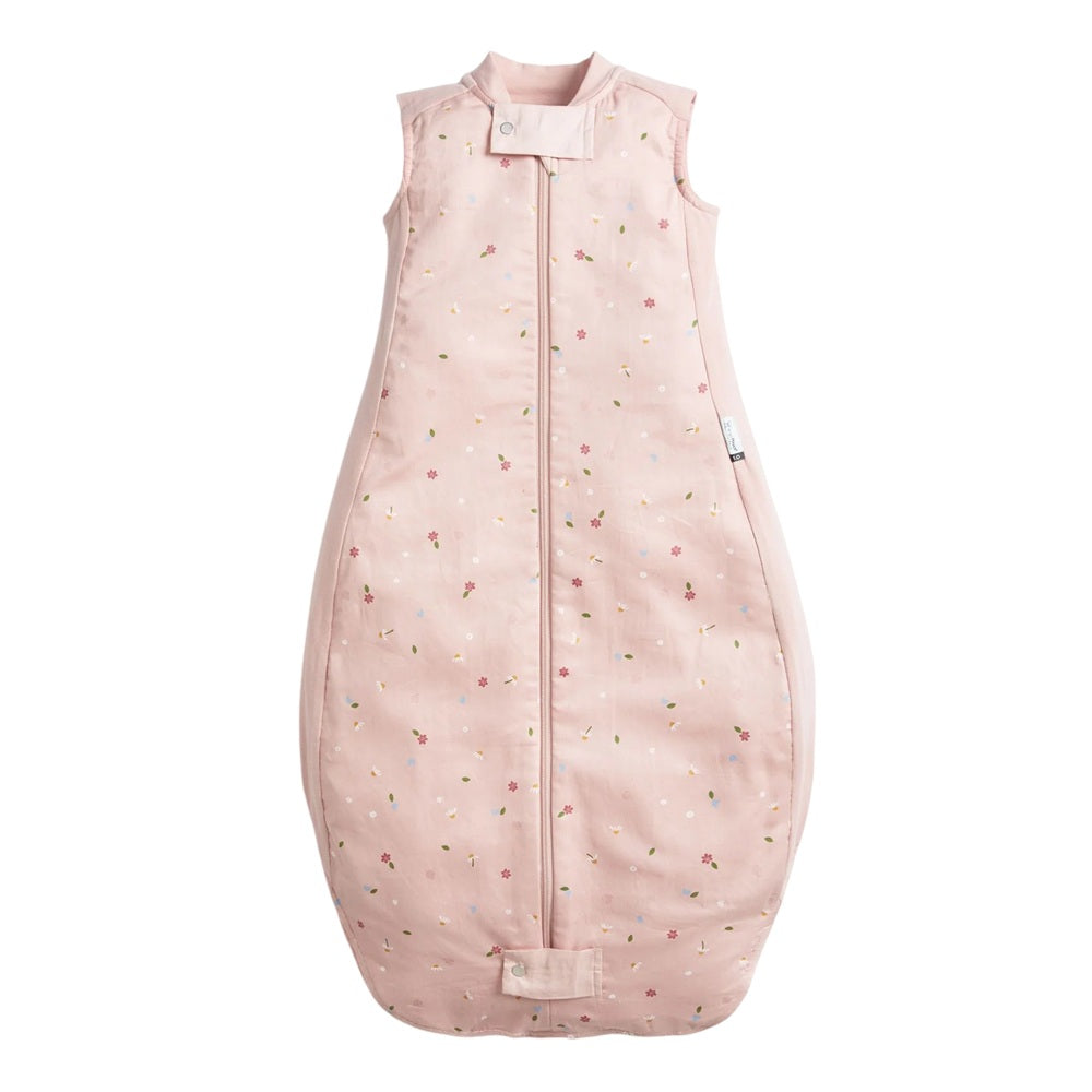 The ErgoPouch 1.0 Tog Premium Sleeping Bag Daisies by ErgoPouch is a light pink, sleeveless bag with a subtle small flower print, front zipper, gently rounded wide fit bottom, and neck snap tab for secure closure.