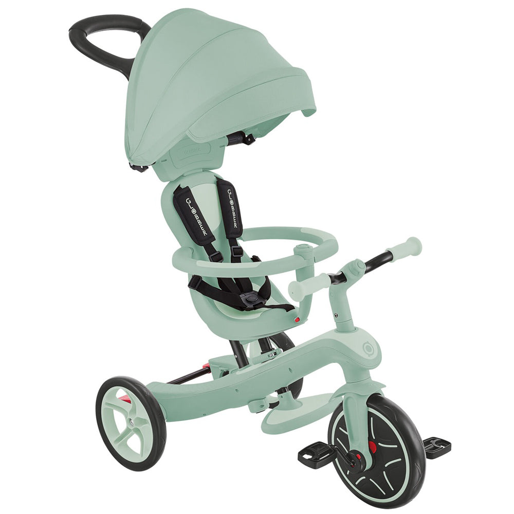 The Globber Explorer Trike 4 in 1 - Ecologic by Globber is a mint green, eco-friendly trike with canopy, adult handlebar, safety harness, child handlebar, footrest & protective bar—an adjustable toddler tricycle for comfort and safety.
