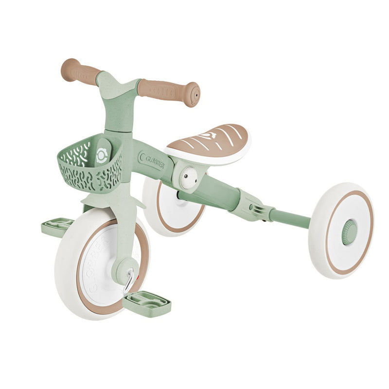 The Globber Learning Trike 2in1 PLUS by Globber is a modern green and white trike with brown accents, front basket, wide seat, and large wheels—perfect for toddlers exploring their world.