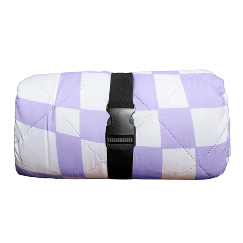 The IZIMINI Ava Picnic Rug by IZIMINI features a purple and white checkered, machine-washable quilt rolled up and secured with a black strap and plastic buckle, making it ideal for picnics.
