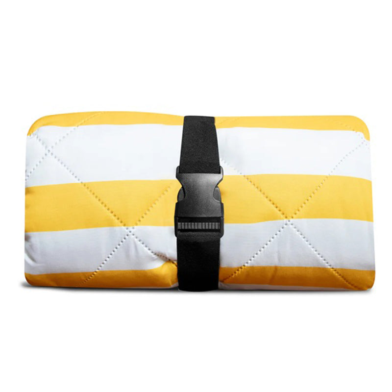 The IZIMINI Brighton Picnic Rug by IZIMINI is a rectangular, machine-washable rug with yellow and white stripes, quilted stitching, and a black strap with buckle—ideal for adding comfort to your picnic setup.