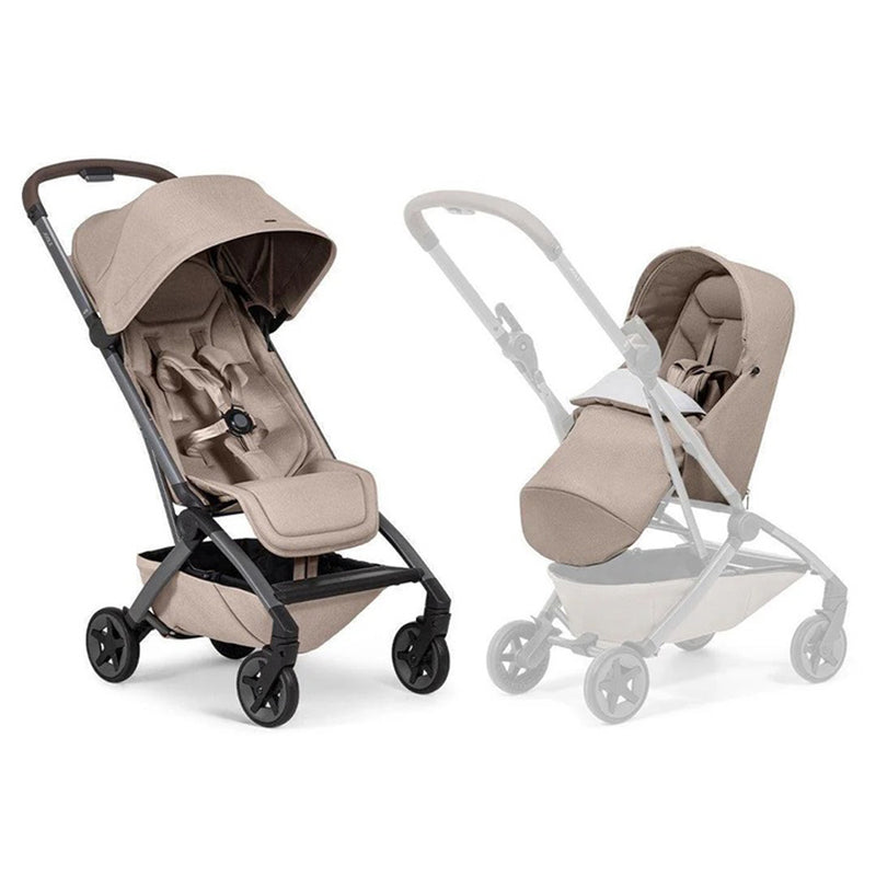 Two beige Joolz Aer2 Stroller + Aer2 Nest To Seat by Baby Village are shown: one upright and fully assembled, the other partially transparent to highlight its detachable bassinet for newborns to toddlers. Both feature black wheels and an under-seat storage basket.