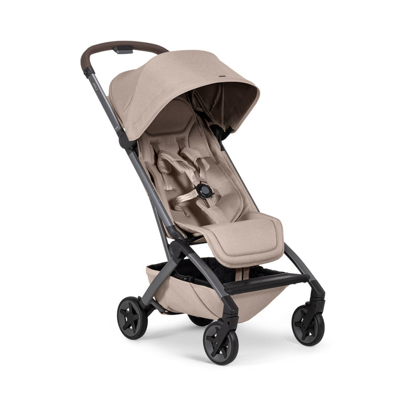 The Joolz Aer2 Stroller by Joolz is an ultra-compact beige stroller with a canopy, safety harness, and four black wheels, displayed at an angle on a white background.