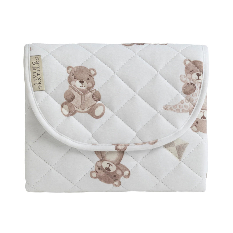 The Living Textiles Foldable Travel Change Mat Cuddly Bear is a white quilted pouch with brown teddy bears, a curved flap, and a tag on the left that reads "Living Textiles." It’s perfect as a portable baby changing mat.