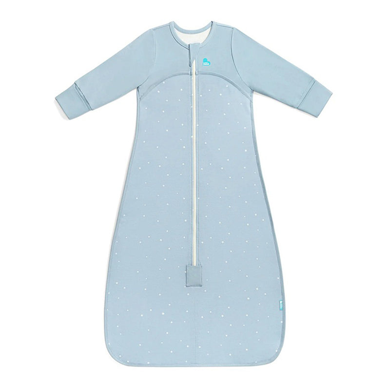 The Love To Dream Sleep Bag 1.0T Stretch Cotton in Twinkle Powder Blue features long solid blue sleeves, a front zipper, white polka dots, and a wide rounded bottom—perfect for cozy and comfortable baby sleep.