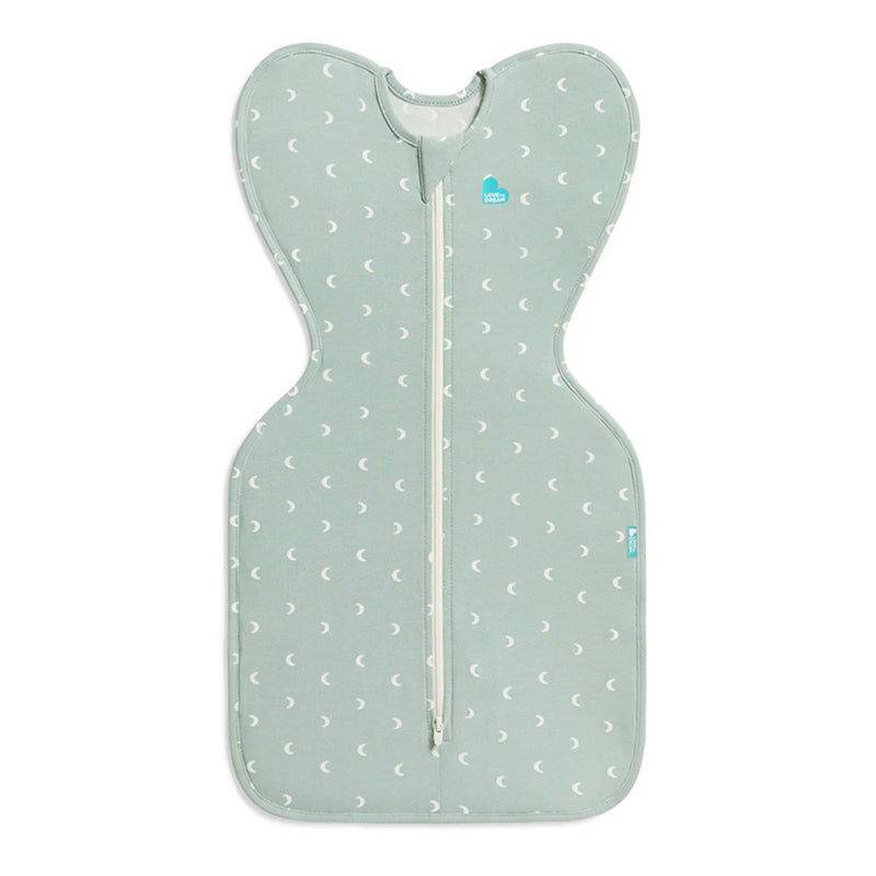 The Love To Dream Swaddle Up 1.0T Stretch Cotton Moon Olive features a light green, butterfly-shaped design with white crescent moons and a central zipper for self-soothing.