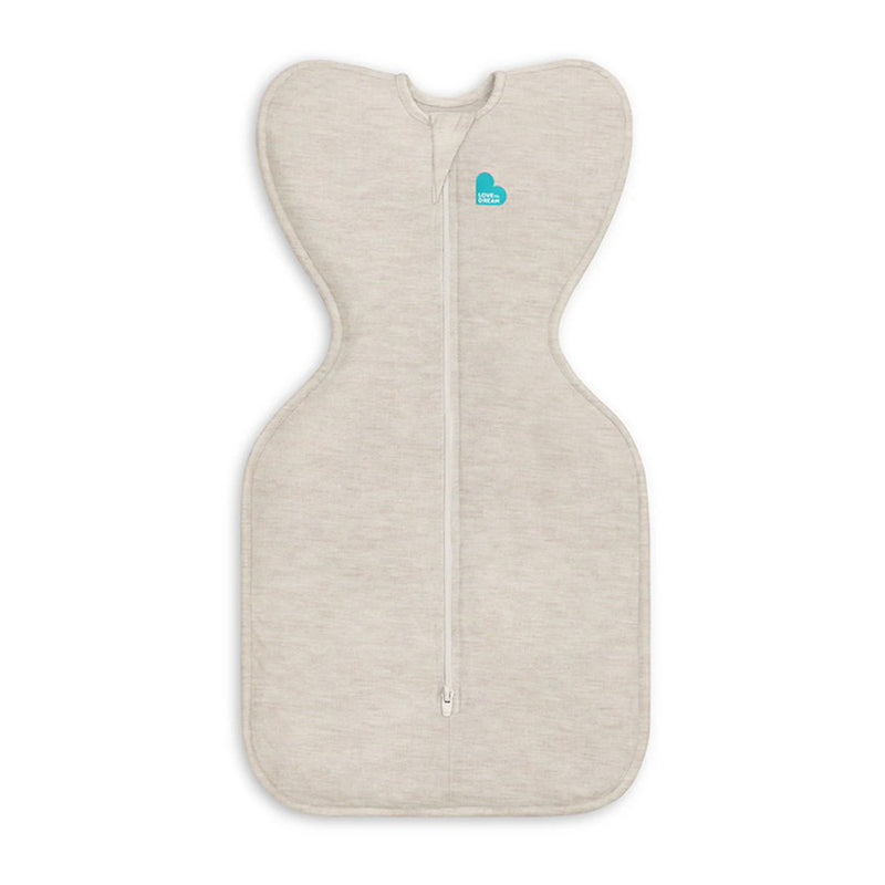 The Love To Dream Swaddle Up 1.0T Stretch Cotton Oatmeal is a beige, cocoon-shaped baby swaddle with a center zipper and teal logo, featuring wide shoulders and fitted body for self-soothing comfort.
