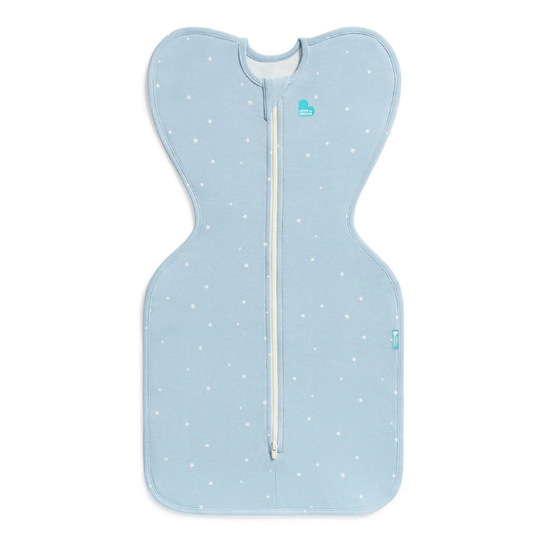 The Love To Dream Swaddle Up 1.0T Stretch Cotton Twinkle Powder Blue is a light blue swaddle sack featuring white stars, a center zipper, and a butterfly shape with wide arms-up sections for comfy, self-soothing sleep.