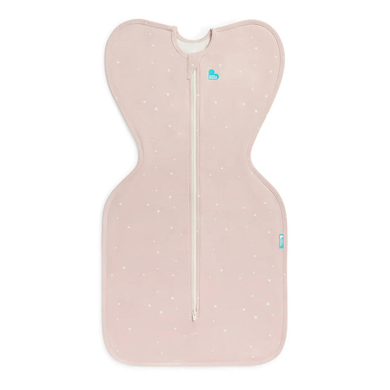 The Love To Dream Swaddle Up 1.0T Stretch Cotton Twinkle Powder Pink, a butterfly-shaped pink baby swaddle with white dots and central zipper, designed for comfort and self-soothing, is laid flat on a white background.