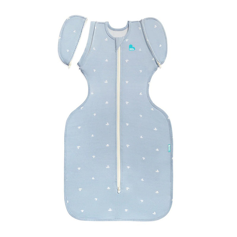 The Love To Dream Swaddle Up Transition Bag 1.0T Viscose From Bamboo Boats Mist Blue features a front zipper, detachable sleeves, and all-over white sailboat prints—perfect for an easy swaddle transition.