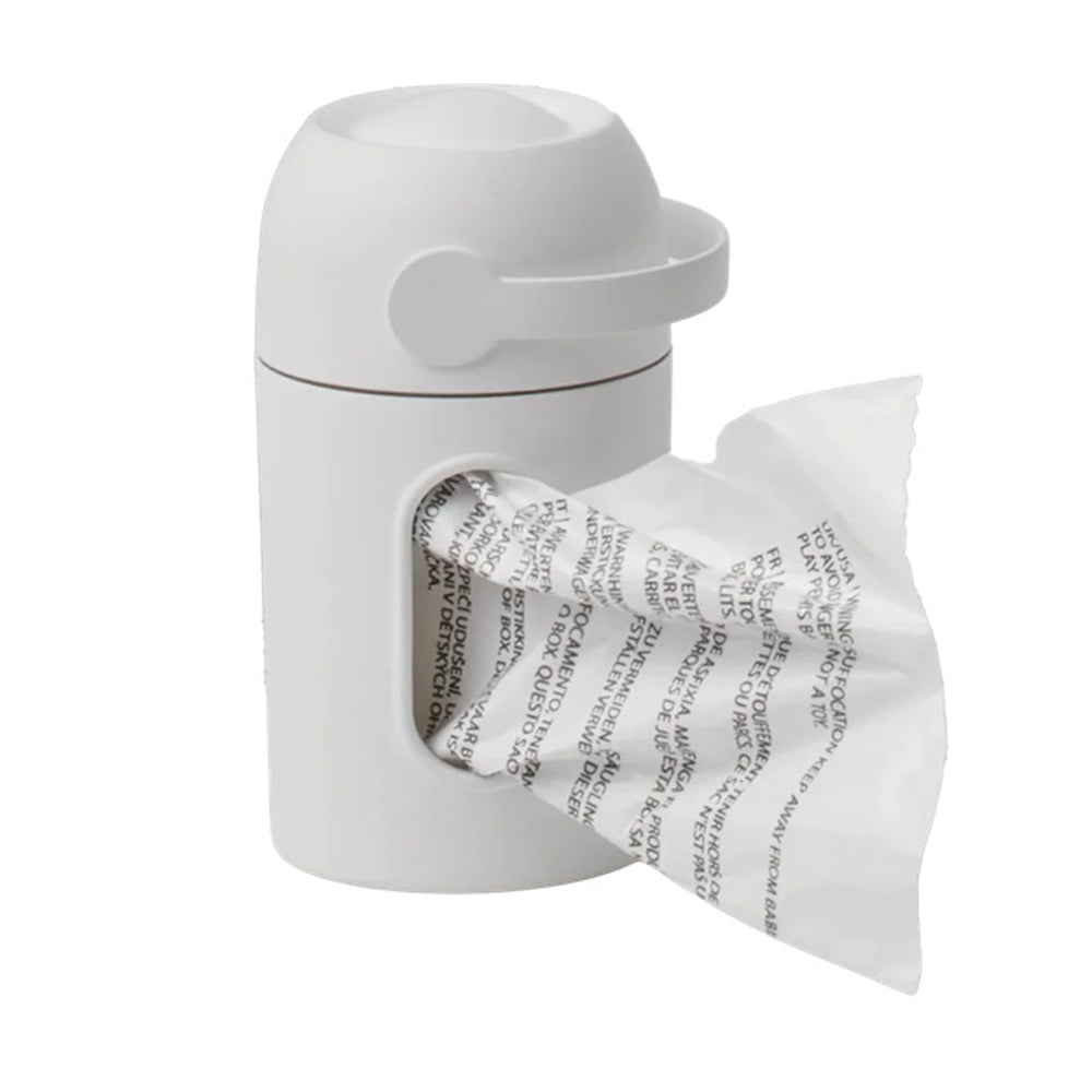 The Magic Nappy Bag Dispenser Complete by Magic is a white, cylindrical dispenser with a round lid and handle, dispensing a roll of bags from its side opening. Includes one roll of bags.