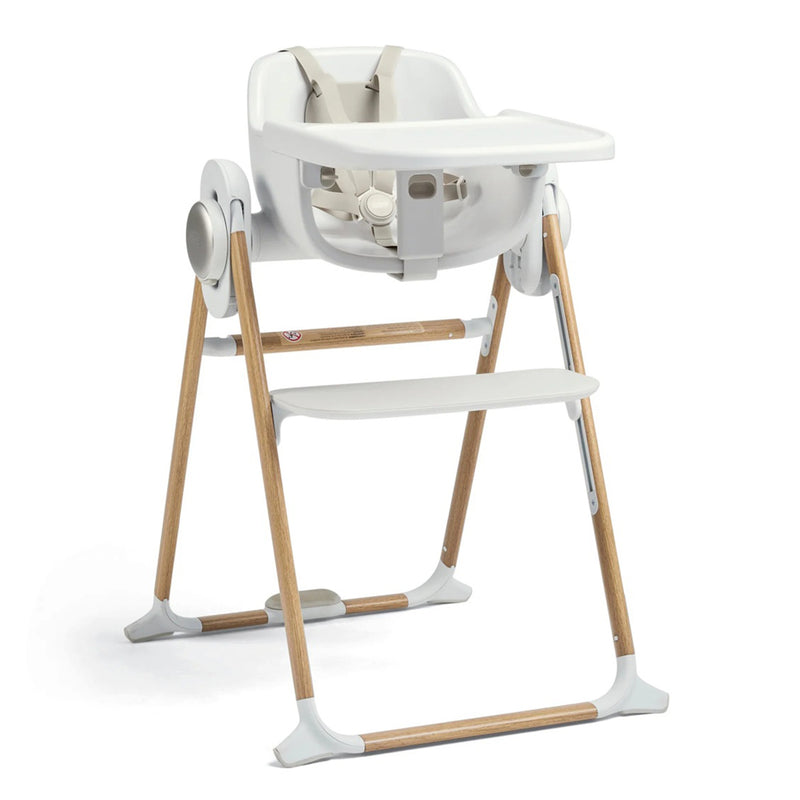 The Mamas & Papas Eno Highchair features a modern white plastic seat, tray, and footrest with light wooden legs and gray plastic feet. A safety harness ensures security—ideal for your baby's weaning journey.