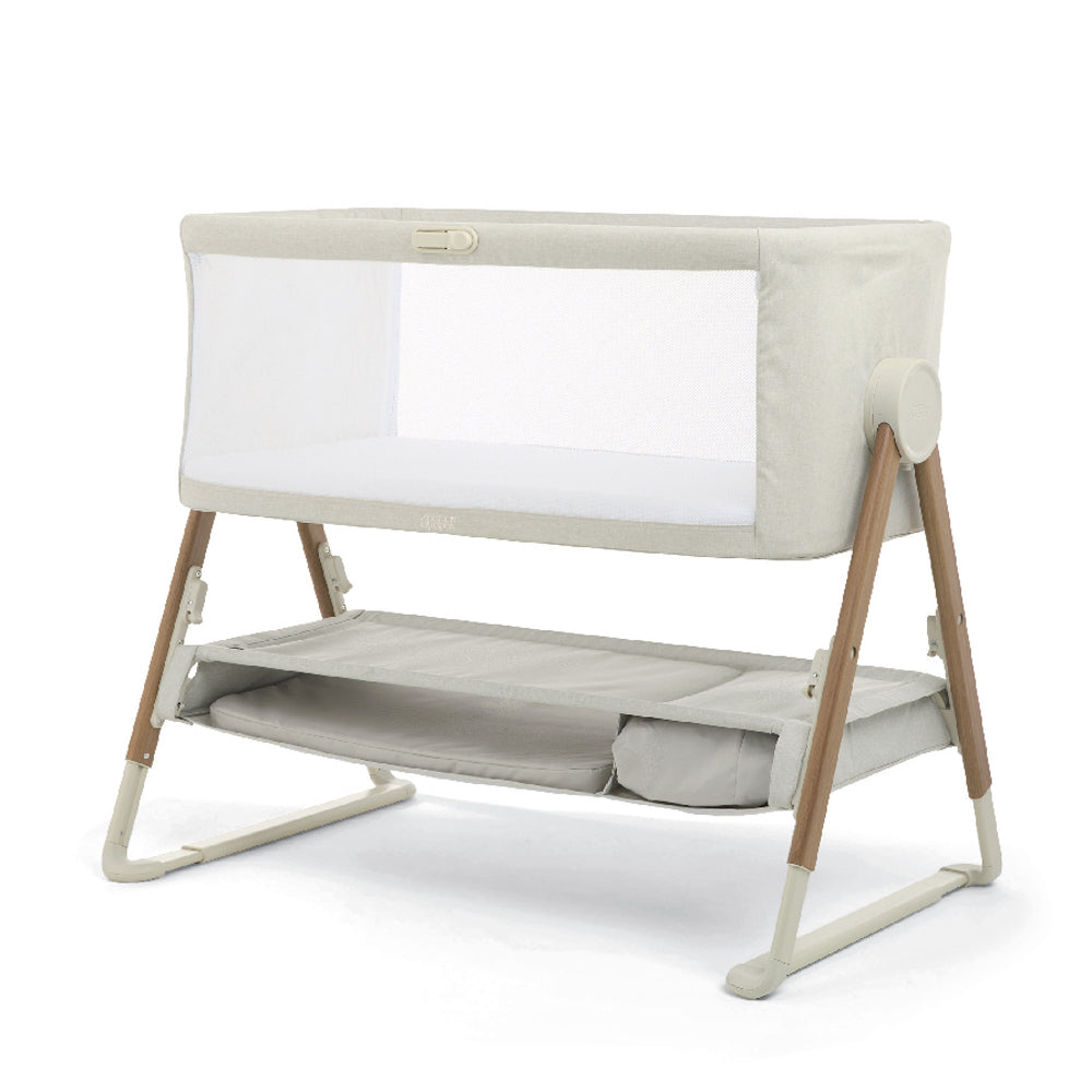 The Mamas & Papas Lua V2 Bedside Cot Fawn features breathable mesh panels, wooden legs, and a lower storage shelf, displayed on a plain white background.