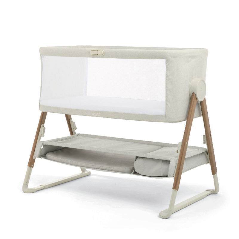 The Mamas & Papas Lua V2 Bedside Cot Fawn features breathable mesh panels, wooden legs, and a lower storage shelf, displayed on a plain white background.