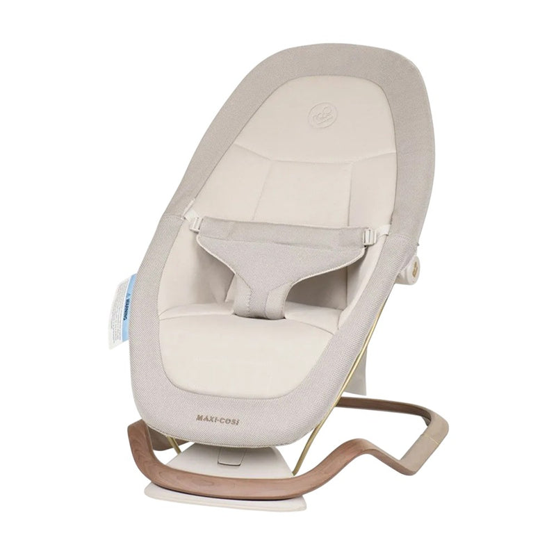 The Maxi Cosi Dove Bouncer Elegance Beige features a padded 3D knit cover, secure harness, and modern wooden base for comfort and gentle rocking.