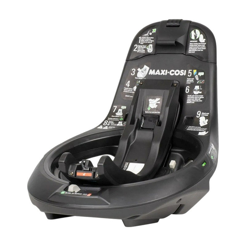 The Maxi Cosi Raia 360 LX Base Only, in black, features printed installation instructions and diagrams, visible attachment points, adjustment mechanisms, and is compatible with various car seats.