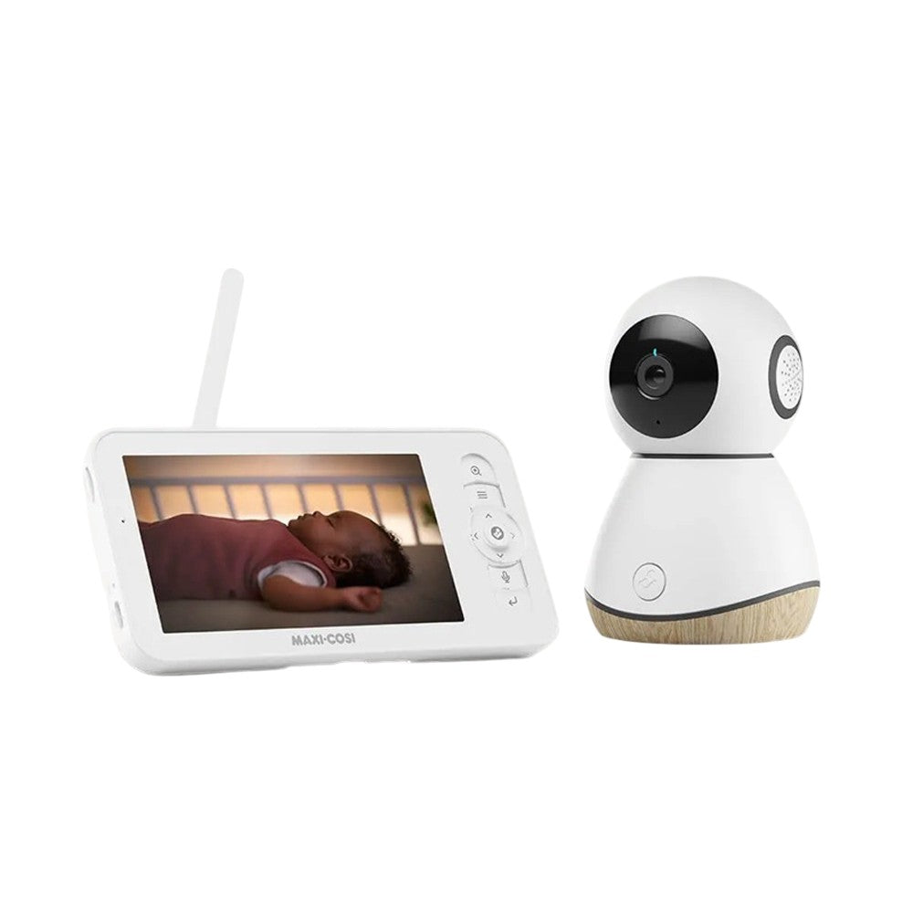 The Maxi Cosi See Pro Baby Monitor by Maxi Cosi features CryAssist technology, a handheld screen showing your baby sleeping, and a separate white night vision camera with a round lens and wooden base.