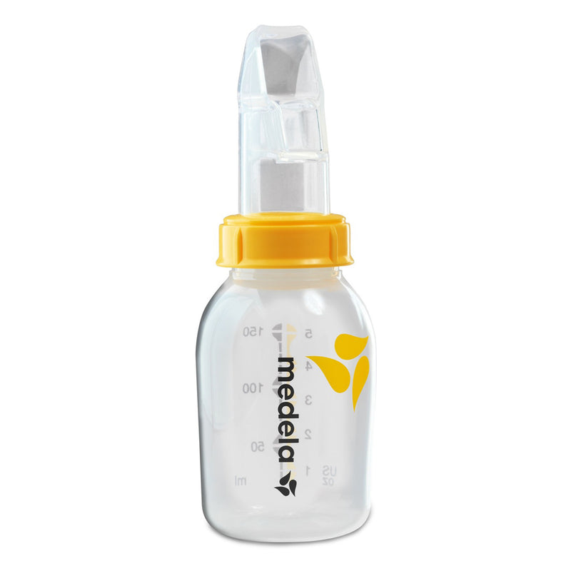 The Medela SoftCup Cup Feeder 80ml is a clear plastic baby bottle with measurement markings, a yellow screw cap, and a specialized transparent nipple for babies with sucking difficulties, featuring the Medela logo.