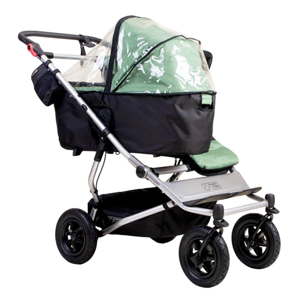The Mountain Buggy Carrycot Plus Storm Cover for V4 Duet is a green and black water-resistant cover, compatible with the Duet Carrycot Plus, designed by Mountain Buggy.