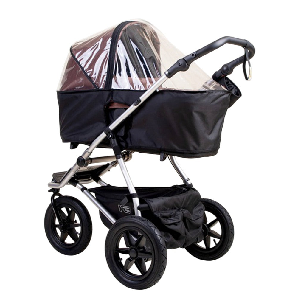 The Mountain Buggy Carrycot Plus Storm Cover for V4 Urban Jungle and Terrain shields the seating area of your black baby stroller with water-resistant protection, large wheels, a storage basket, a curved handle, and carrycot plus compatibility.