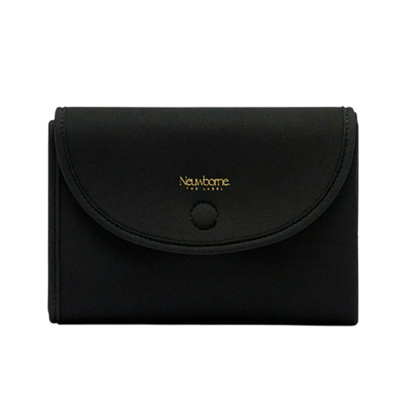 A black, rectangular Neuwborne Milana Neoprene Change Mat with a curved flap, magnetic closure, and gold "Neuwborne" logo on the front—styled like a portable wallet—set against a plain white background.