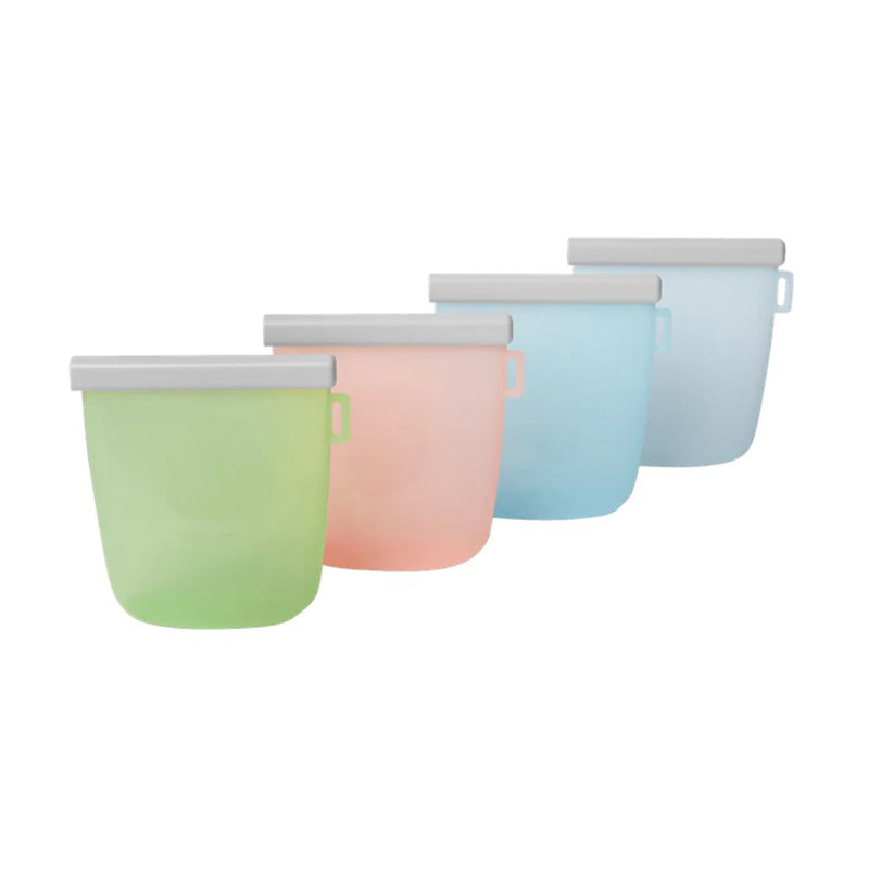 New Beginnings Silicone Storage Bags 4pk by New Beginnings—four reusable bags in green, pink, blue, and white with white sealing strips, ideal for snacks or breast milk storage—are arranged in a row on a white background.