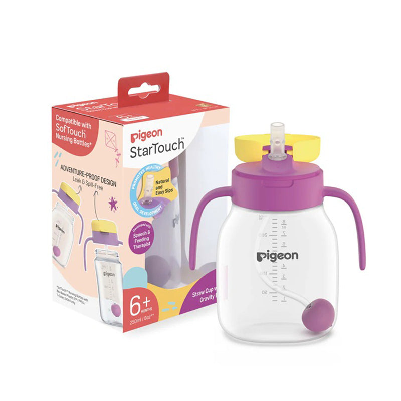 A Pigeon Startouch Toddler Cup for ages 6+ months is shown beside its packaging. The cup features purple handles, a yellow lid, a clear body with measurement markings, and a purple weighted ball for easy straw drinking.