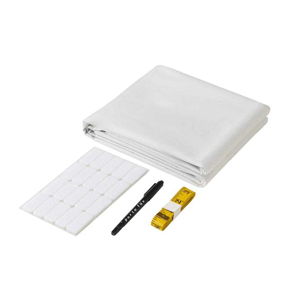 The Porta Fox Cut-to-Size Blackout Blind Cream set by Porta Fox includes a foldable cream fabric sheet, rectangular adhesive tabs, a black marker pen, and a yellow measuring tape, displayed on a white background.