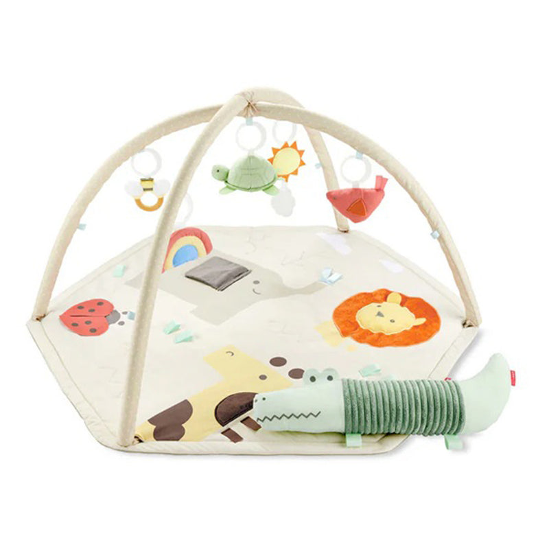 The Skip Hop Geometric Wonders Activity Gym features a soft hexagonal mat with animal prints, two crossed arches with sensory toys, and a plush green crocodile—ideal from tummy time to playtime.