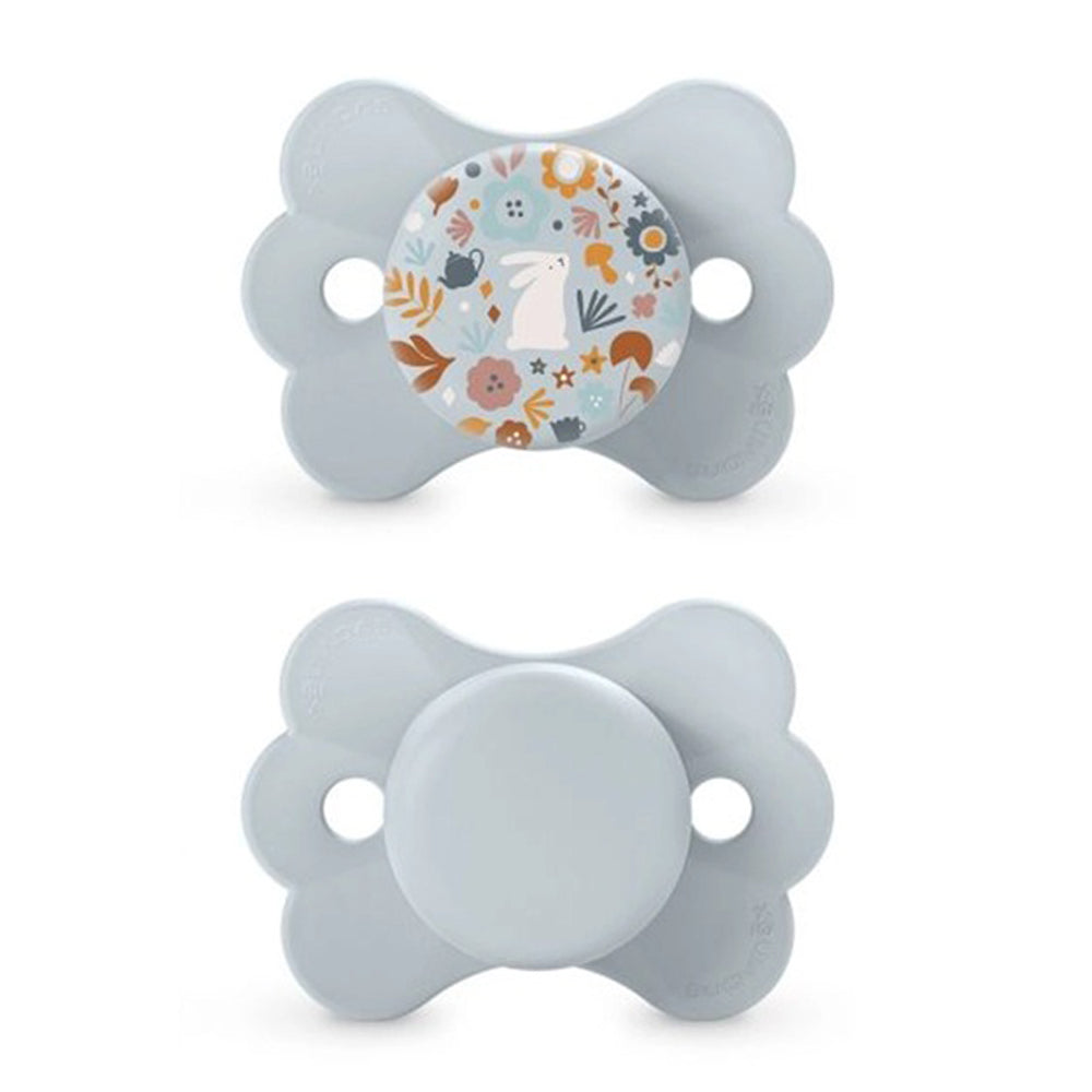 Suavinex Wonderland Butterfly SX Pro Soother 6-18 Months 2 Pack includes two light gray pacifiers: one with a colorful floral and bunny design, one plain. Both feature butterfly-shaped shields and the SX Pro silicone teat.