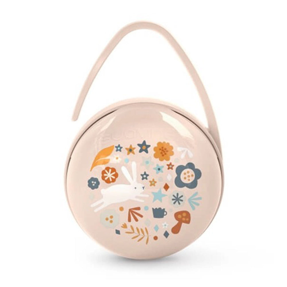 The Suavinex Wonderland Soother Case is a round, light pink BPA-free case with a flexible handle, featuring a white rabbit and vibrant flowers, leaves, and mushrooms in orange, blue, and brown tones.