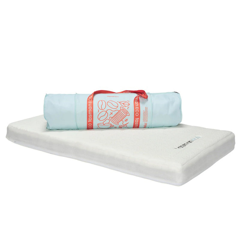 A white Seena DuoDreamer Mattress topper is laid flat with a rolled-up blue carrying bag with red accents and handles, designed to perfectly complement the Seena pocket spring cot mattress that meets Australian standards.
