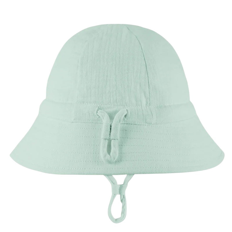 The Toshi Bell Hat Sammy Sage by Toshi is a light mint green, bell-shaped sunhat with a wide brim and chin strap, crafted from soft organic cotton—ideal for sunny days.