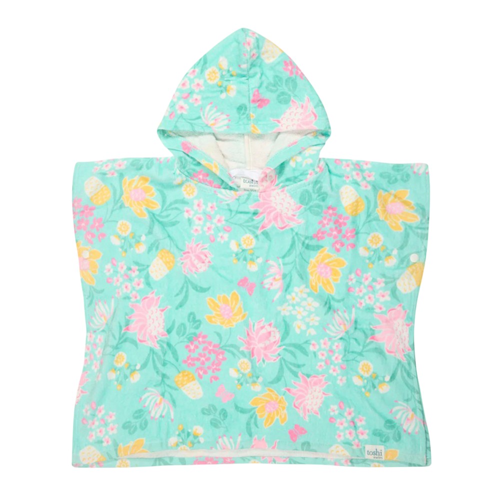 The Toshi Hooded Towel Paradise Waratah Mint is a children's cotton poncho towel with a light blue background, pink, yellow, and white tropical floral and pineapple patterns. It features a front pocket, UPF 50+ sun protection, and a "Toshi" tag.