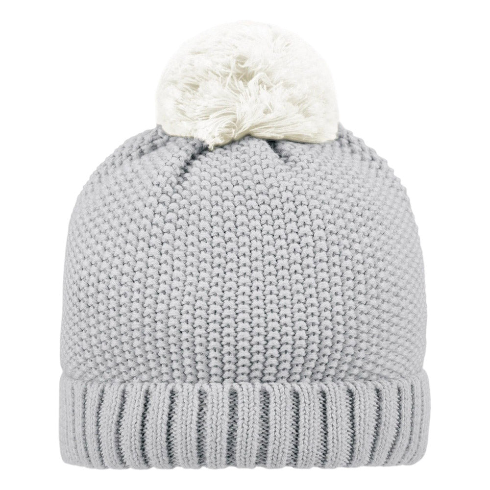 The Toshi Organic Beanie Bobby Fog by Toshi is a light gray beanie made from organic cotton, featuring a thick ribbed brim and a fluffy white pom-pom on top.