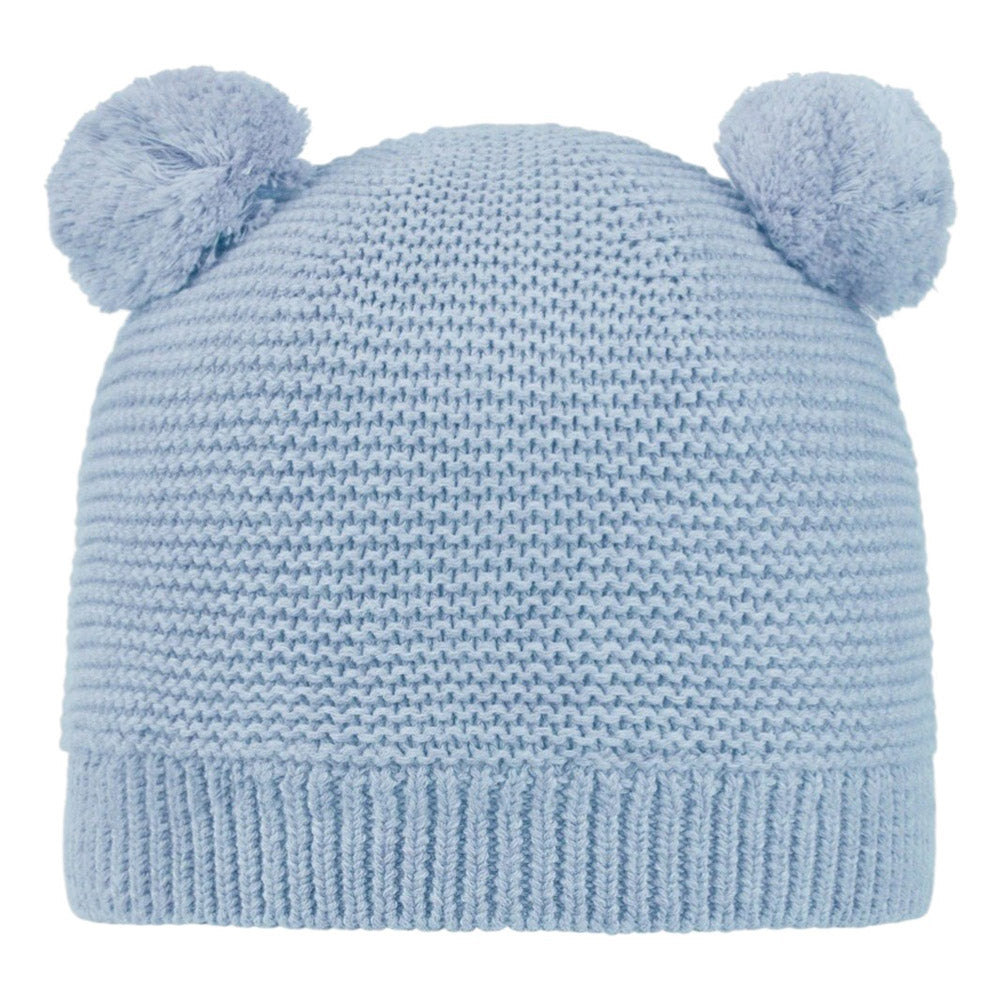 The Toshi Organic Beanie Snowy Bluebell is a light blue knitted baby hat with two pom-poms like bear ears, featuring a textured pattern and ribbed folded brim for added warmth and comfort.