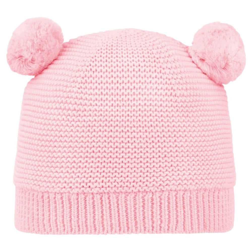 The Toshi Organic Beanie Snowy Misty Rose is a pink organic cotton baby beanie by Toshi, featuring two fluffy pom-poms on top that look like cute bear ears.