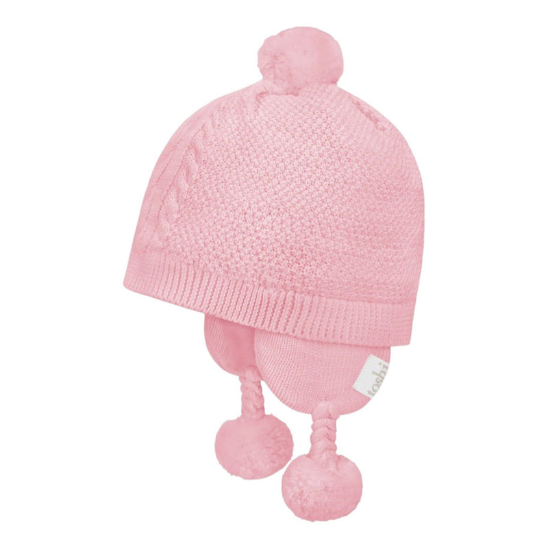 The Toshi Organic Earmuff Yummy Misty Rose by Toshi is a light pink organic cotton baby hat featuring ear flaps with braided tassels and cute pom-poms—ideal as a cozy newborn winter hat.
