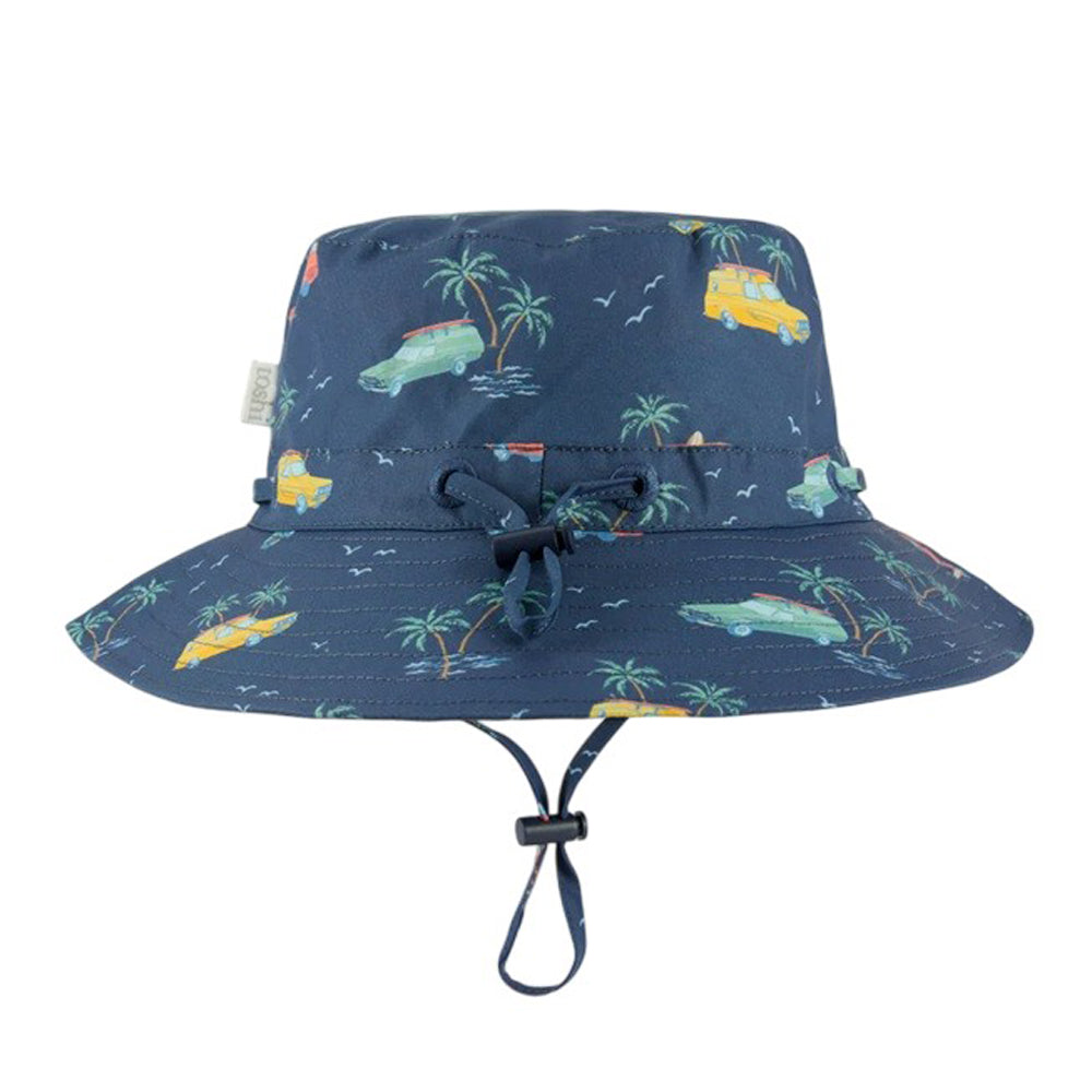 The Toshi Sunhat Banjo Swell Seekers is a navy blue children's cotton hat with green and yellow palm trees, cars, and vans. It features a wide brim, adjustable chin strap, crown drawstring, and provides UPF 50+ sun protection.