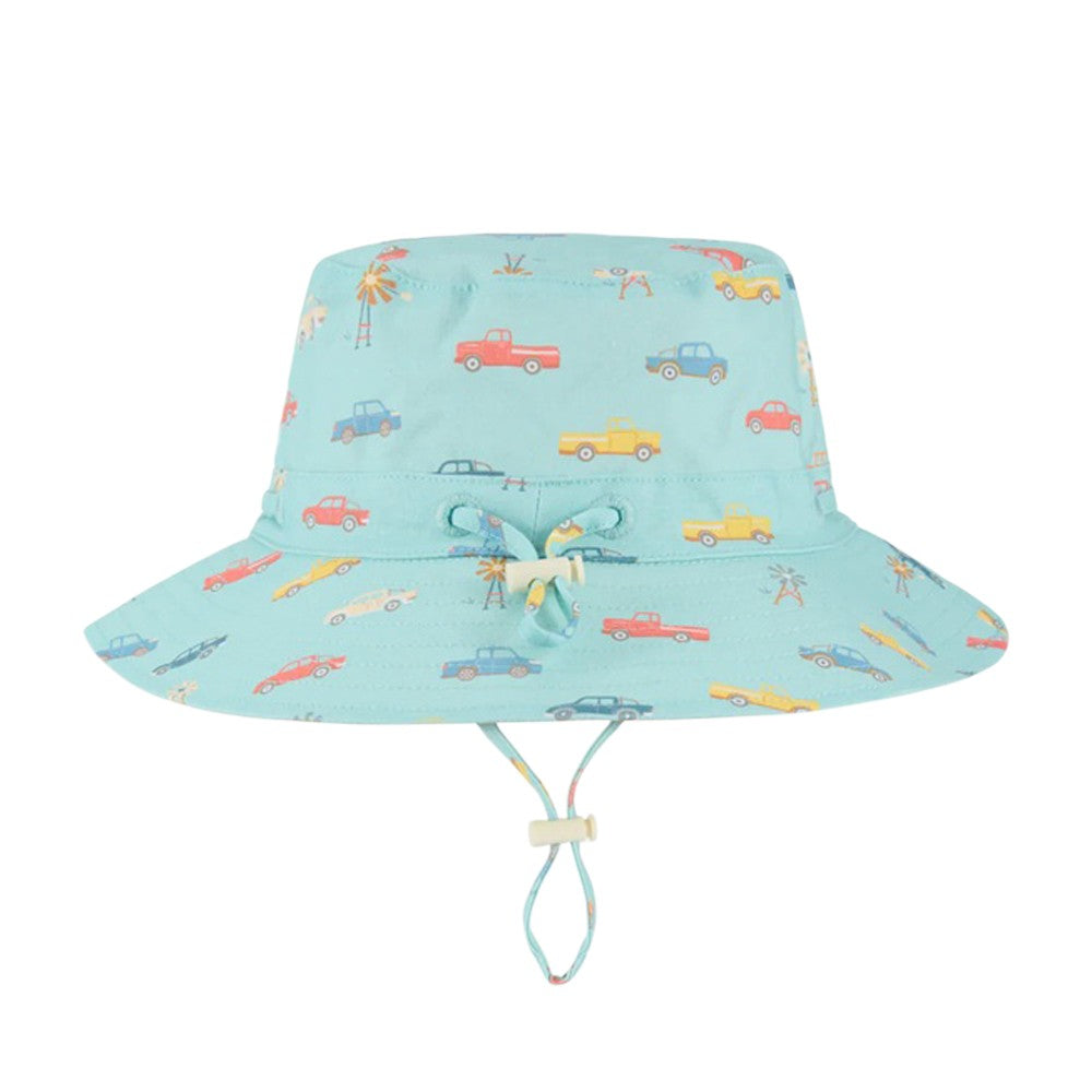 The Toshi Sunhat Ryder Utes Teal is a light blue children’s sunhat with UPF 50+ protection, a wide brim, chin strap, and colorful car-themed designs.