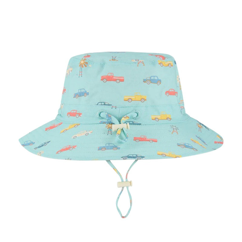 The Toshi Sunhat Ryder Utes Teal is a light blue children’s sunhat with UPF 50+ protection, a wide brim, chin strap, and colorful car-themed designs.