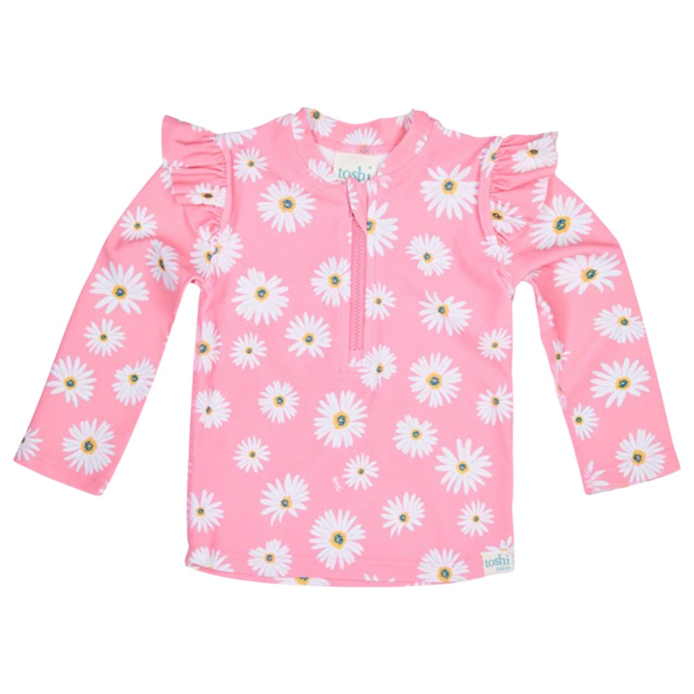 The Toshi Swim Rashie L/S Ripple Daisy Watermelon features long sleeves, white daisy prints, ruffled shoulders, a front zipper, and UPF50+—perfect children's swimwear or for pairing with other Toshi pieces on sunny days.
