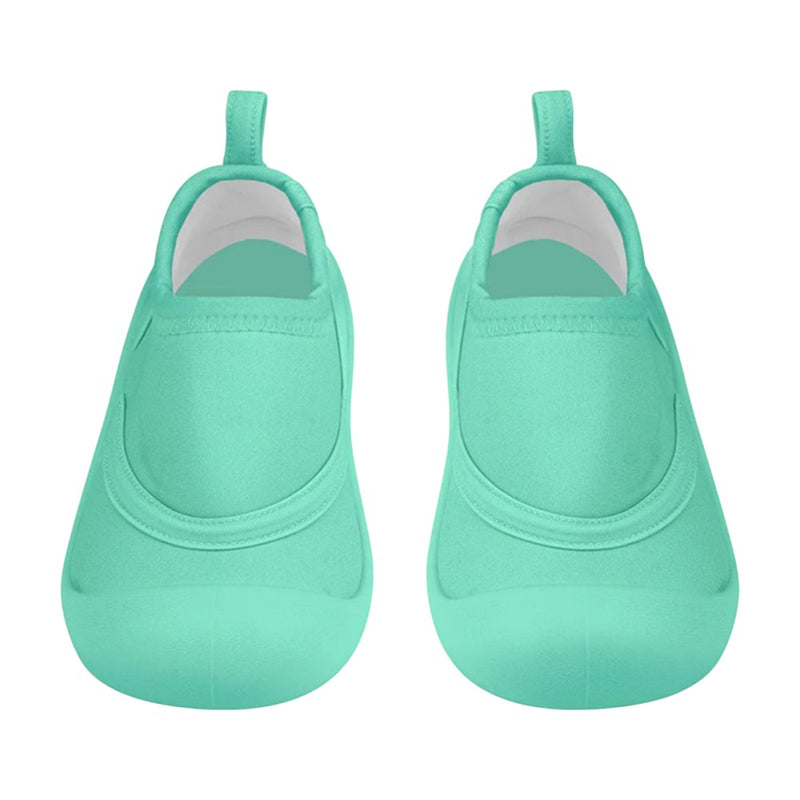 A pair of Toshi Swim Reef Booties Beachcomber Seagrass by Toshi, featuring aqua neoprene, rounded toes, and back pull tabs, displayed from above on a white background.