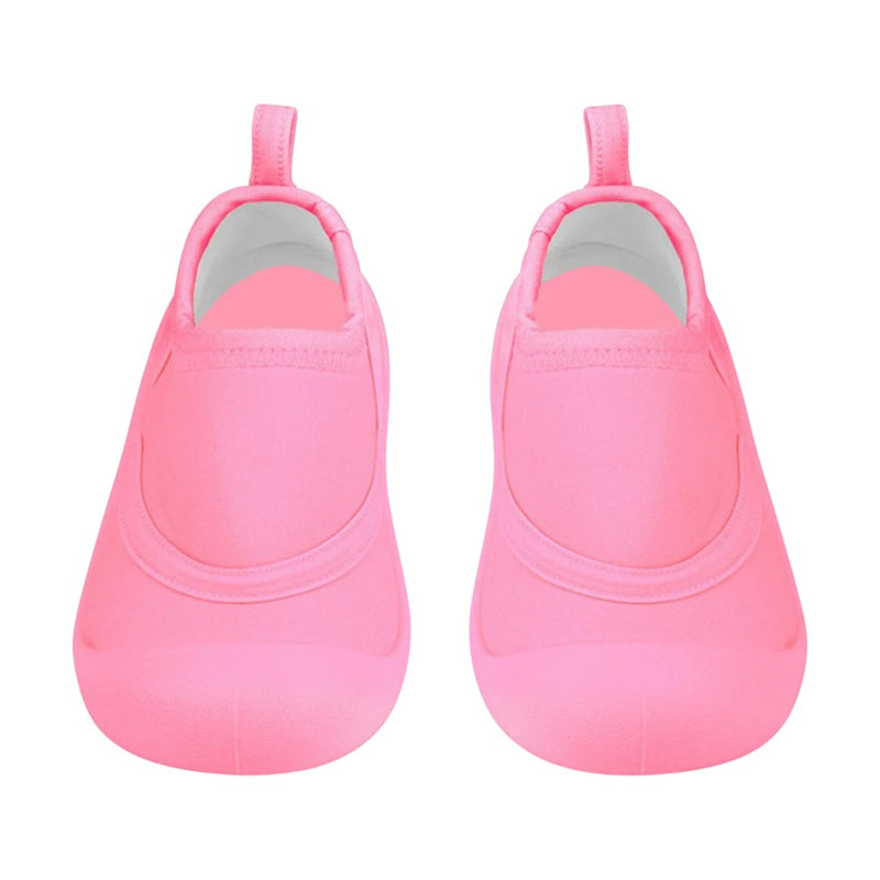 Toshi Swim Reef Booties Beachcomber Watermelon by Toshi, bright pink neoprene baby booties with rounded toes, white interiors, skid-resistant soles, and back pull tabs, displayed side by side on a white background.