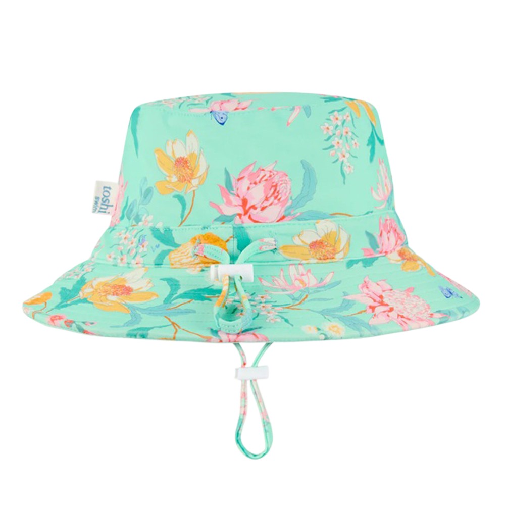 The Toshi Swim Sunhat Paradise Waratah Mint is a light teal bucket hat with a colorful floral pattern, adjustable chin strap, and UPF50+ sun protection—an ideal choice for baby swimwear.