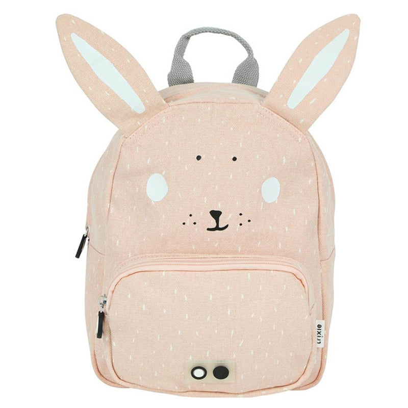 The Trixie Backpack Mrs Rabbit by Trixie is a light pink kids backpack designed like a rabbit, with tall ears, cute face details, adjustable shoulder straps, a front pocket, and a small side tag.