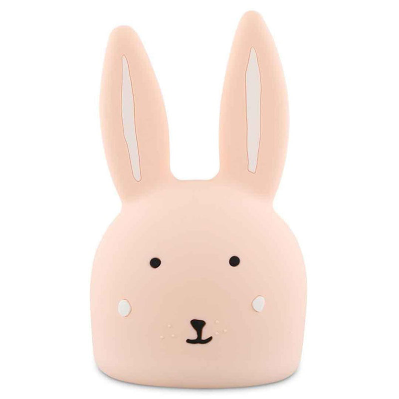The Trixie Night Light Mrs Rabbit by Trixie is a soft pink bunny-shaped silicone night light with long ears, minimal facial details, and gentle black eyes—perfect for a soothing bedtime glow.