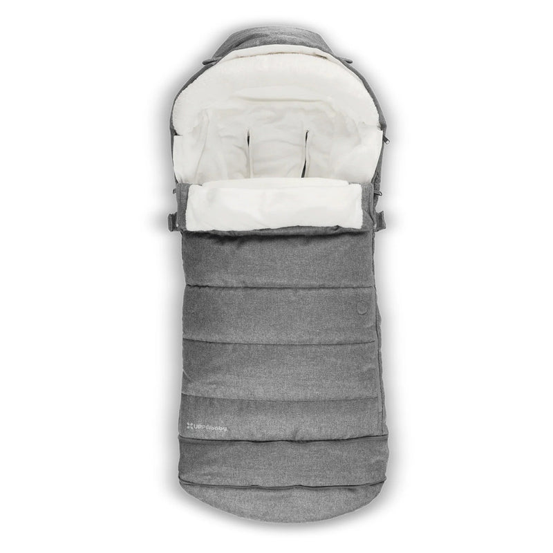 The UPPAbaby Cosy Ganoosh 2025, in gray with a soft white interior, is shown unzipped and open from above on a white background. Its cozy lining suits all seasons—perfect for UPPAbaby prams.
